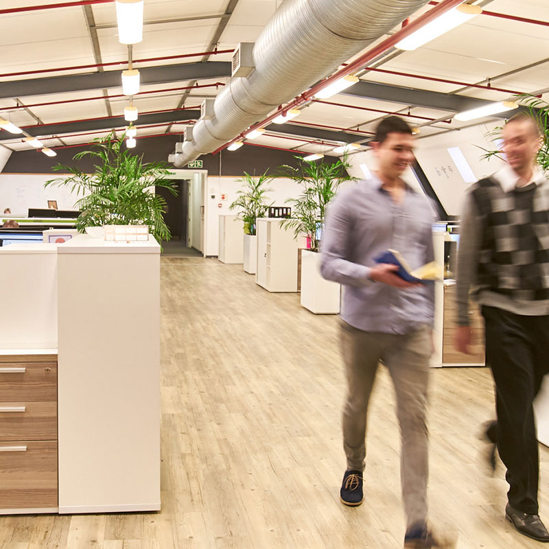 Employees walking in Van As Associates department